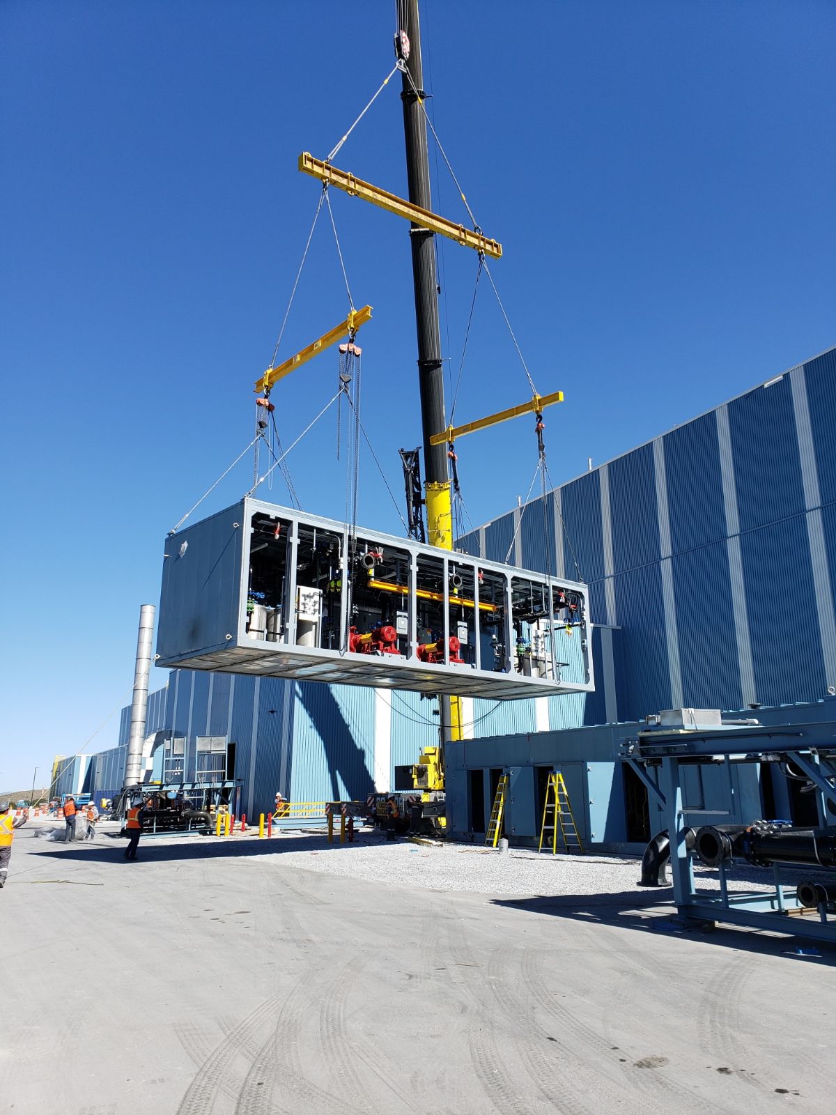 Photo of crane lifting modular chiller plant